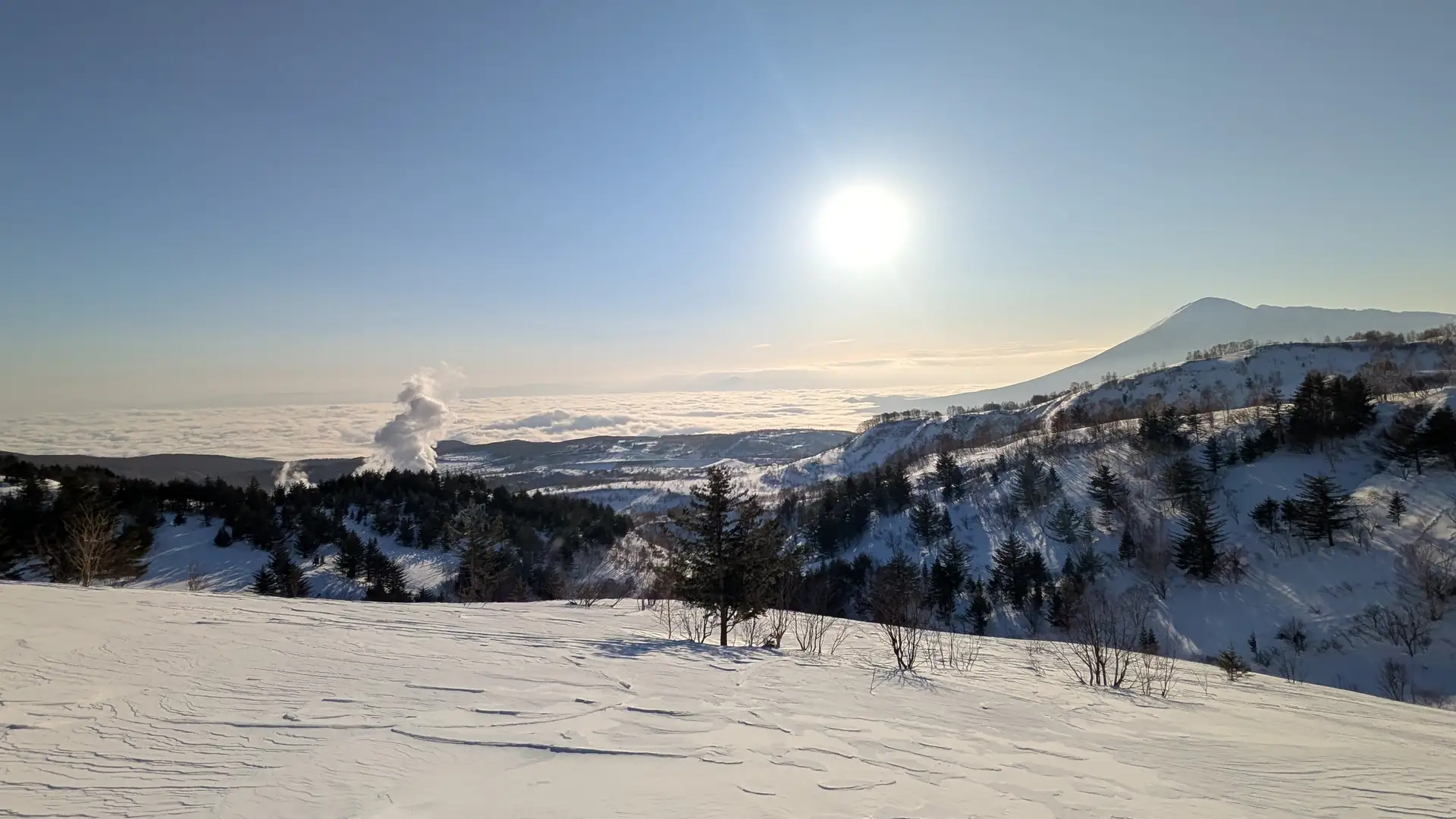 Sunrise over a sea of clouds with geothermal steam rising from the Matsukawa valley
